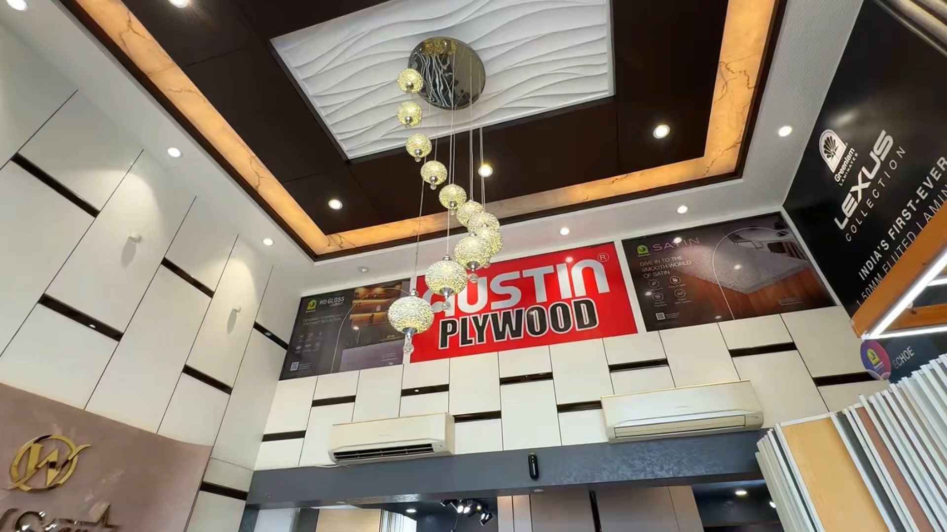 The showroom ceiling: cove lighting, a wave-panel ceiling and a chandelier of glass globes